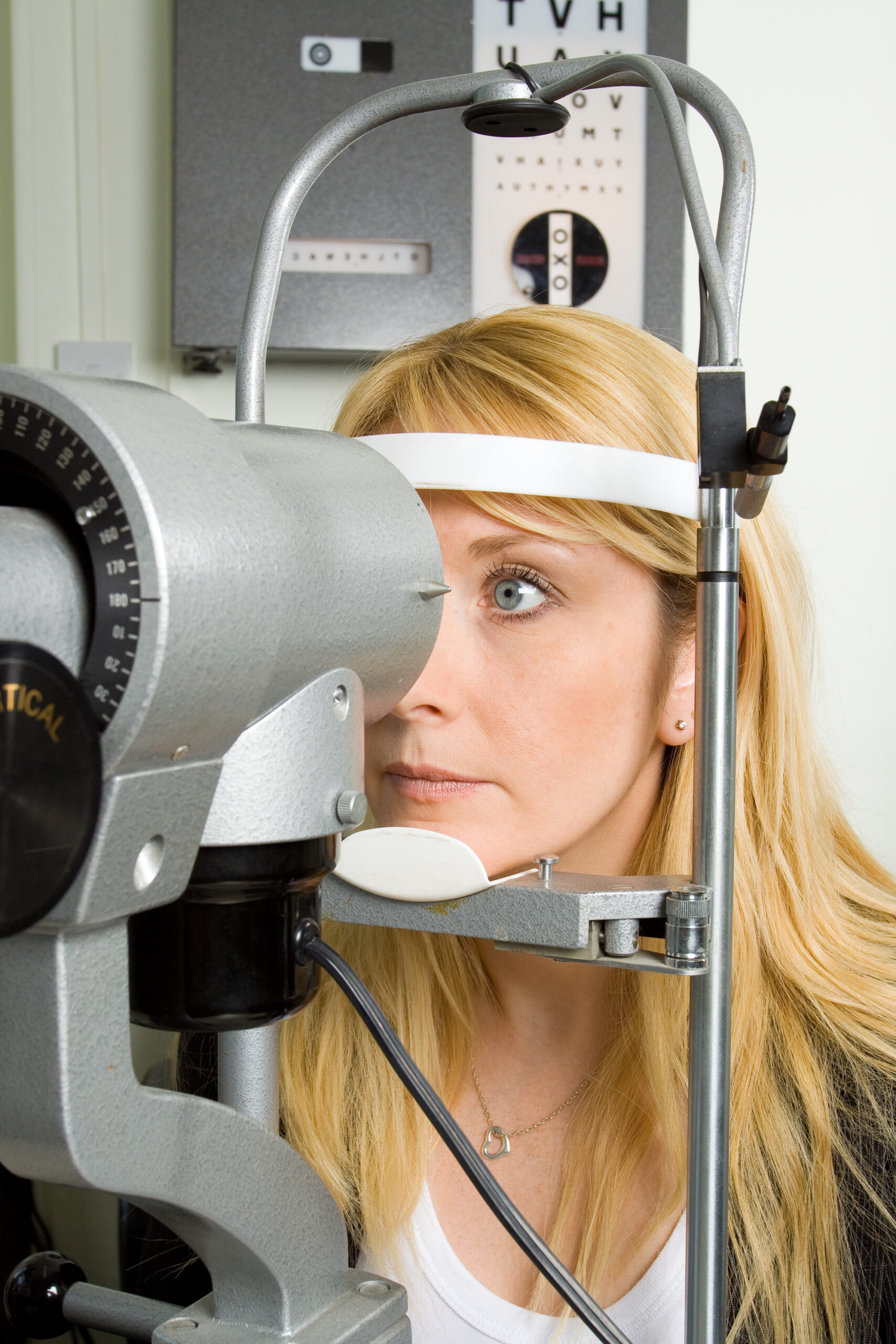 Attractive young woman having an eyesight examination at an optician's clinic